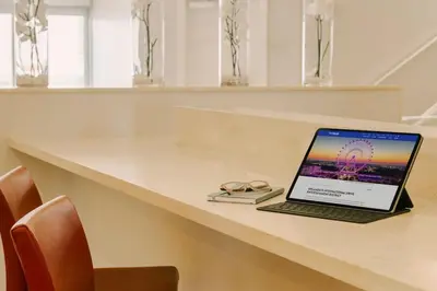 a laptop sitting on a table in a room at The Point by Edge in Orlando