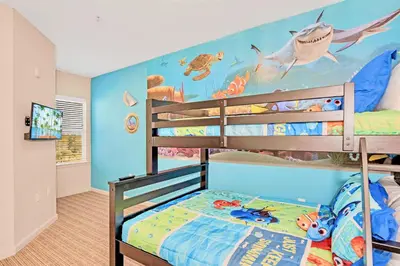 a bedroom with a bunk bed with a fish mural on the wall at Modern 3BR Near Disney - Pool in Orlando