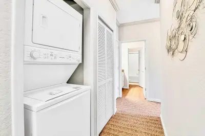 a white laundry room with a washer and dryer at Refreshing 3BR Apartment Near Disney - Pool and Hot Tub! in Orlando