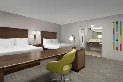 a hotel room with two beds and a desk at Hampton Inn & Suites Orlando North Altamonte Springs in Orlando