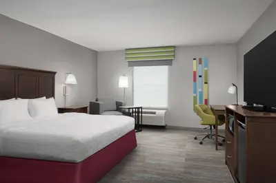 a hotel room with a bed and a desk and a television at Hampton Inn & Suites Orlando North Altamonte Springs in Orlando