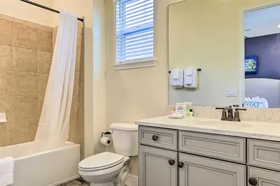 a bathroom with a toilet and a sink and a shower at Home with Hot Tub 4 Mi to Disney! in Orlando