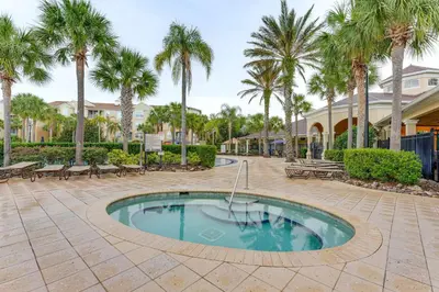 a swimming pool with palm trees in a courtyard at Private Cocktail Pool Kissimmee Resort Retreat! in Orlando