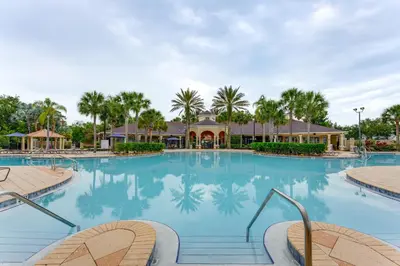 a large swimming pool at a resort with palm trees at Private Cocktail Pool Kissimmee Resort Retreat! in Orlando