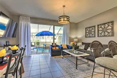 a living room with a couch and a table at Private Cocktail Pool Kissimmee Resort Retreat! in Orlando