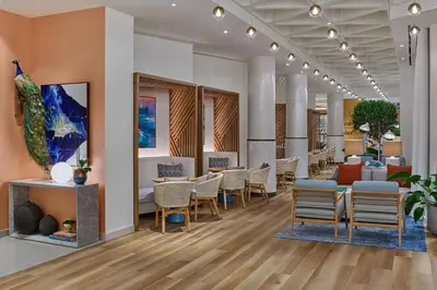 a waiting area in a hospital with chairs and tables at Walt Disney World Swan Reserve in Orlando