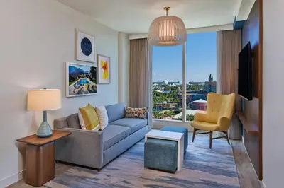 a living room with a couch and a tv at Walt Disney World Swan Reserve in Orlando