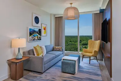 a living room with a couch and a tv at Walt Disney World Swan Reserve in Orlando