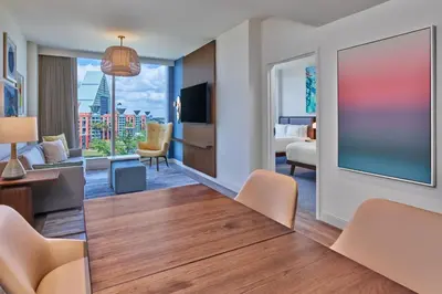 a hotel room with a dining table and a living room at Walt Disney World Swan Reserve in Orlando