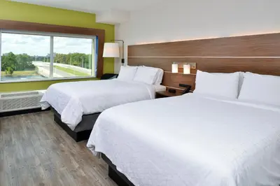 two beds in a hotel room with a window at Holiday Inn Express Orlando - South Park by IHG in Orlando