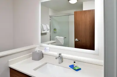 a bathroom with a sink and a mirror at Holiday Inn Express Orlando - South Park by IHG in Orlando