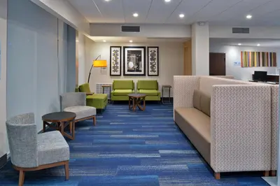 a waiting room with chairs and a couch at Holiday Inn Express Orlando - South Park by IHG in Orlando