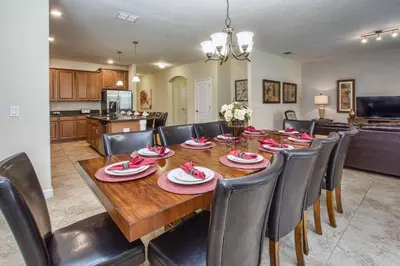 a dining room and kitchen with a table and chairs at Sunny Escape, Pool, Spa, Resort-3509Pp in Kissimmee
