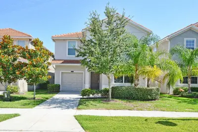 a white house with a tree and a driveway at Sunny Escape, Pool, Spa, Resort-3509Pp in Kissimmee