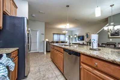 a kitchen with a refrigerator and a counter top at Dog Friendly Townhome Wsplashpool- 1600St in Kissimmee