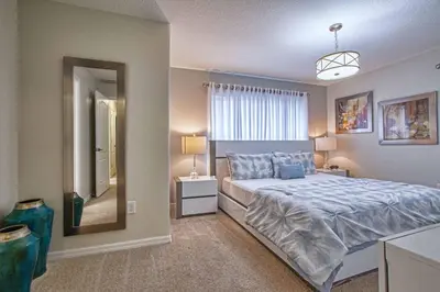 a bedroom with a bed and a large window at Dog Friendly Townhome Wsplashpool- 1600St in Kissimmee