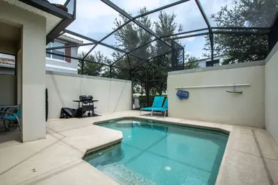 a swimming pool in the middle of a patio at Dog Friendly Townhome Wsplashpool- 1600St in Kissimmee