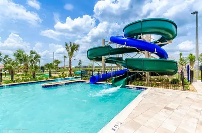 a water slide in a pool at a resort at Dog Friendly Townhome Wsplashpool- 1600St in Kissimmee