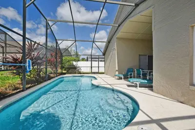 a swimming pool in the middle of a house at Indian Ridge - 4 Bedroom Pool Home- 2408Ir in Orlando