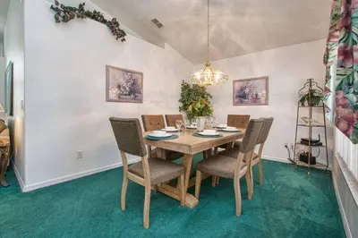 a dining room with a wooden table and chairs at Indian Ridge - 4 Bedroom Pool Home- 2408Ir in Orlando