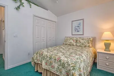 a bedroom with a bed and a lamp and a door at Indian Ridge - 4 Bedroom Pool Home- 2408Ir in Orlando