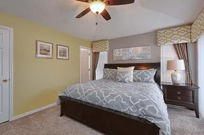 a bedroom with a bed and a ceiling fan at Serene Pool & Spa, Gated Resort- 2201Em in Kissimmee