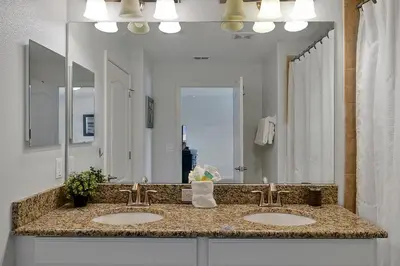 a bathroom with two sinks and a large mirror at Rare Waterfront Wspashpool, Resort -3091Pp in Kissimmee