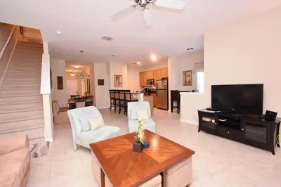 a living room with a couch and a tv and a table at Paradise Palms -5 Bed Townhome W-Splashpool-3046Pp in Kissimmee