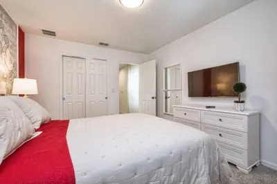 a bedroom with a bed and a flat screen tv at 5 Bedrooms Townhome W- Splashpool - 8205Sa in Orlando