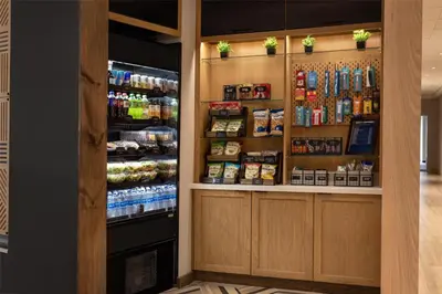 a grocery store aisle with a refrigerated refrigerator at Hyatt Place Orlando Airport in Orlando