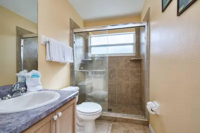 a bathroom with a shower and a toilet and a sink at Indian Ridge- 4 Bedroom Pool Home- 2405Ir in Orlando