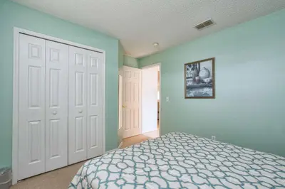 a bedroom with green walls and a bed and a door at Indian Ridge- 4 Bedroom Pool Home- 2405Ir in Orlando