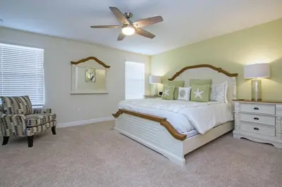 a bedroom with a bed and a ceiling fan at Comfortable Spacious-6 Bed Pool Home - 1675Str in Kissimmee