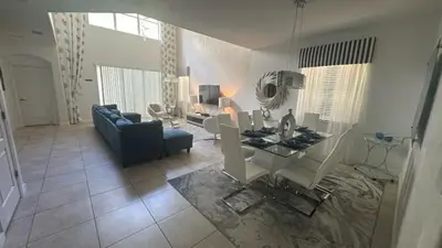 a living room with a blue couch and a table at Pool Home With Privacy, Bbq, Mickey Room - 3500Pp in Kissimmee