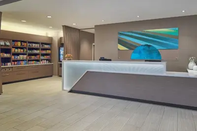 a lobby with a reception desk and a painting on the wall at SpringHill Suites by Marriott Orlando Lake Nona in Orlando