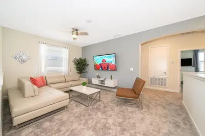 a living room with a couch and a table at 2769RP VILLA 5 BED/5 BA (SANITIZED) in Kissimmee