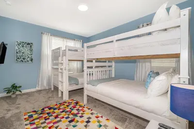 a bedroom with two bunk beds and a rug at 2764SG VILLA 5 BED/5 BA (SANITIZED) in Kissimmee