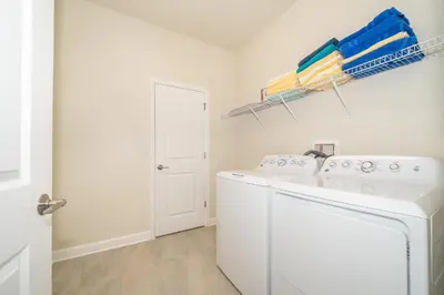 a laundry room with a washer and dryer at 2764SG VILLA 5 BED/5 BA (SANITIZED) in Kissimmee