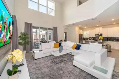 a living room with white furniture and a flat screen tv at 2764SG VILLA 5 BED/5 BA (SANITIZED) in Kissimmee