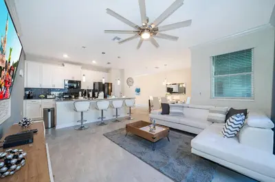 a living room with a white couch and a ceiling fan at 4313SL TOWNHOUSE 4 BEDROOMS & 3 BATHROOMS + POOL in Kissimmee