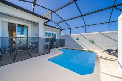 a house with a swimming pool on a balcony at 4393MO TOWNHOUSE 5 BEDROOMS & 4 BATHROOMS + POOL in Kissimmee
