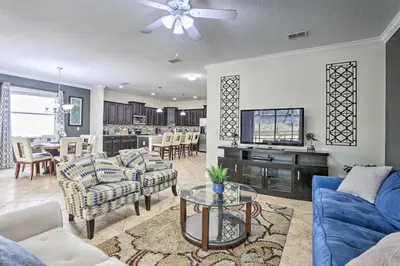 a living room with a couch and a table at Paradise Palms Home with Pool, 6 Mi to Disney! in Kissimmee
