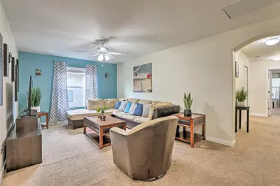 a living room with a couch and a table at Paradise Palms Home with Pool, 6 Mi to Disney! in Kissimmee