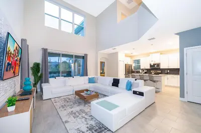 a living room with a white couch and a table at 2811AS VILLA 5 BED/5 BA (SANITIZED) in Kissimmee