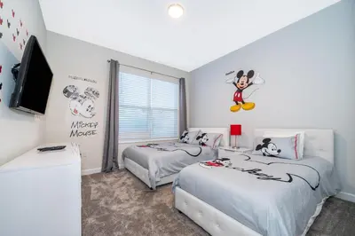 a bedroom with two beds and a tv in it at 2811AS VILLA 5 BED/5 BA (SANITIZED) in Kissimmee