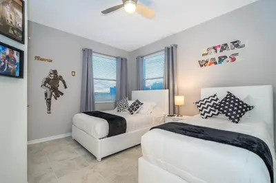 a bedroom with two beds and a ceiling fan at 3150-308BR STOREY LAKE, CONDO 3/2 POOL VIEW in Kissimmee