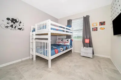 a white bunk bed in a white room with a crib at 3180-201JB STOREY LAKE, CONDO 3/2 GARDEN VIEW in Kissimmee