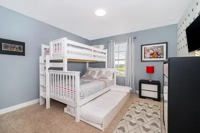 a bedroom with a white bunk bed with a ladder at 3151LS TOWNHOUSE 4 BEDROOMS & 3 BATHROOMS + POOL in Kissimmee