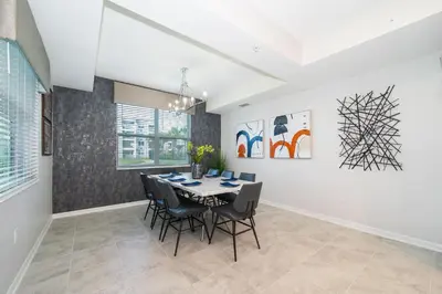 a dining room with a table and chairs at 3180-103EF STOREY LAKE, CONDO 2/2 GARDEN VIEW in Kissimmee