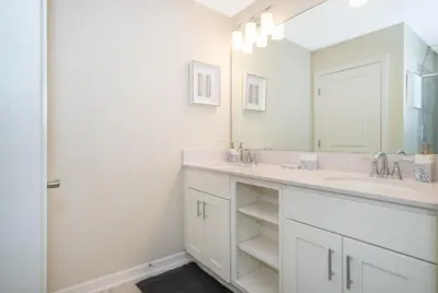 a bathroom with two sinks and a large mirror at 3180-103EF STOREY LAKE, CONDO 2/2 GARDEN VIEW in Kissimmee